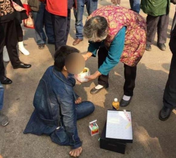 残疾小伙双手不便好心奶奶一口一口喂他